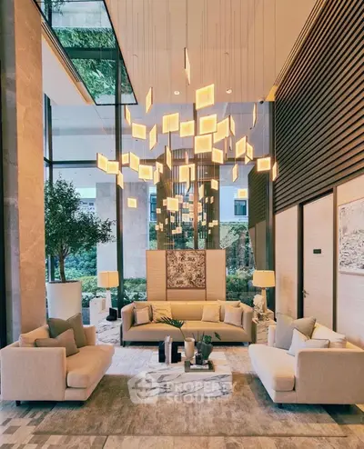 Luxurious modern living room with high ceilings and elegant lighting in a stylish apartment.