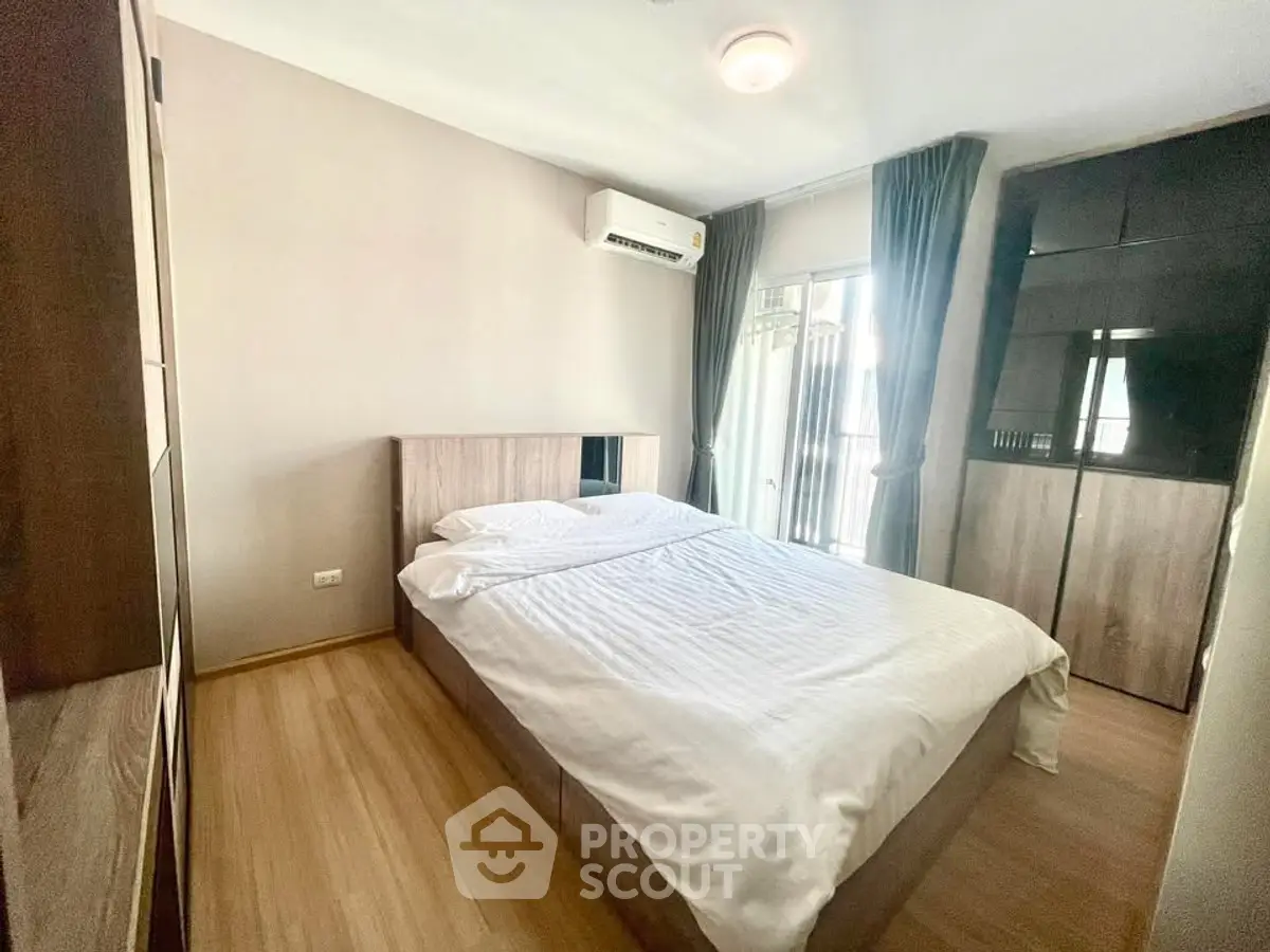 Cozy bedroom with modern furnishings and natural light in a stylish apartment.