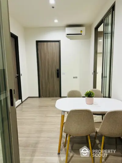 Modern dining area with stylish table and chairs in a cozy apartment setting