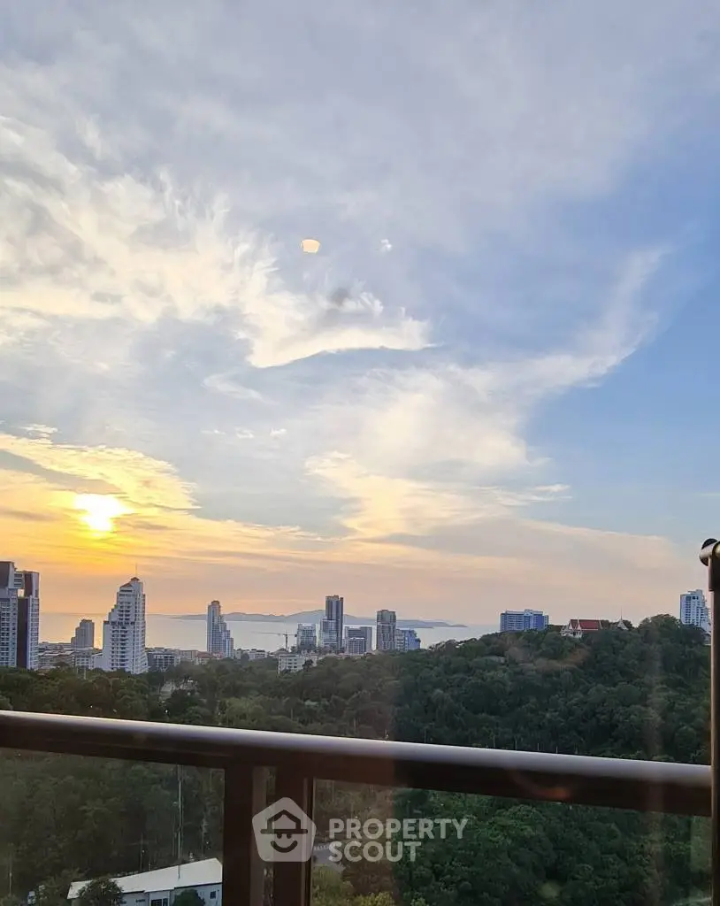 Stunning city skyline view from a high-rise balcony at sunset.