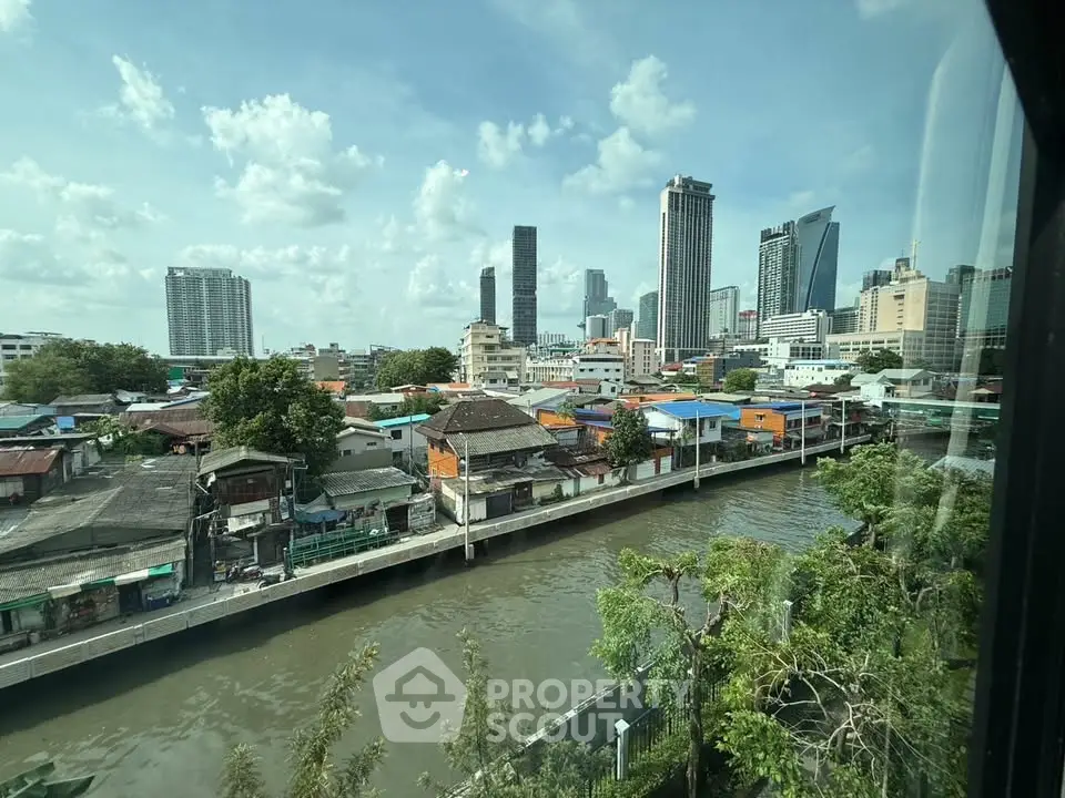 Stunning cityscape view from a high-rise building overlooking a river and urban skyline.