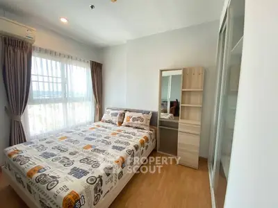 Bright and cozy bedroom with modern decor and ample natural light.