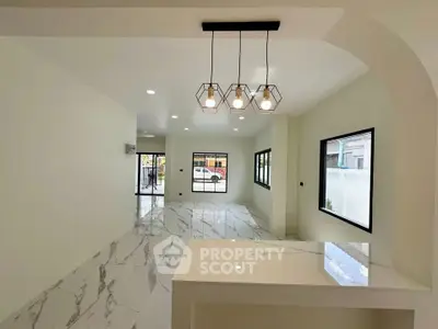 Spacious modern living room with elegant lighting and marble flooring