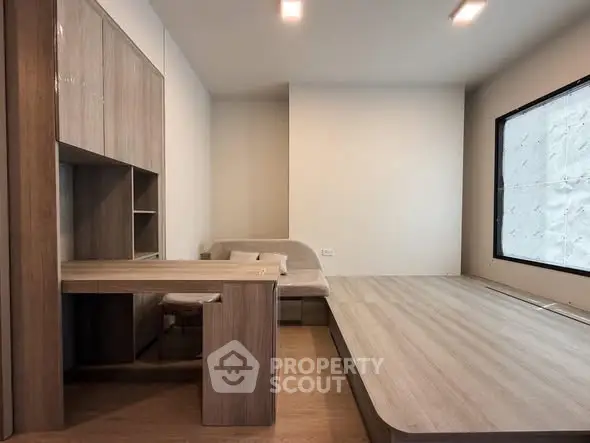 Modern minimalist living room with wooden flooring and built-in furniture