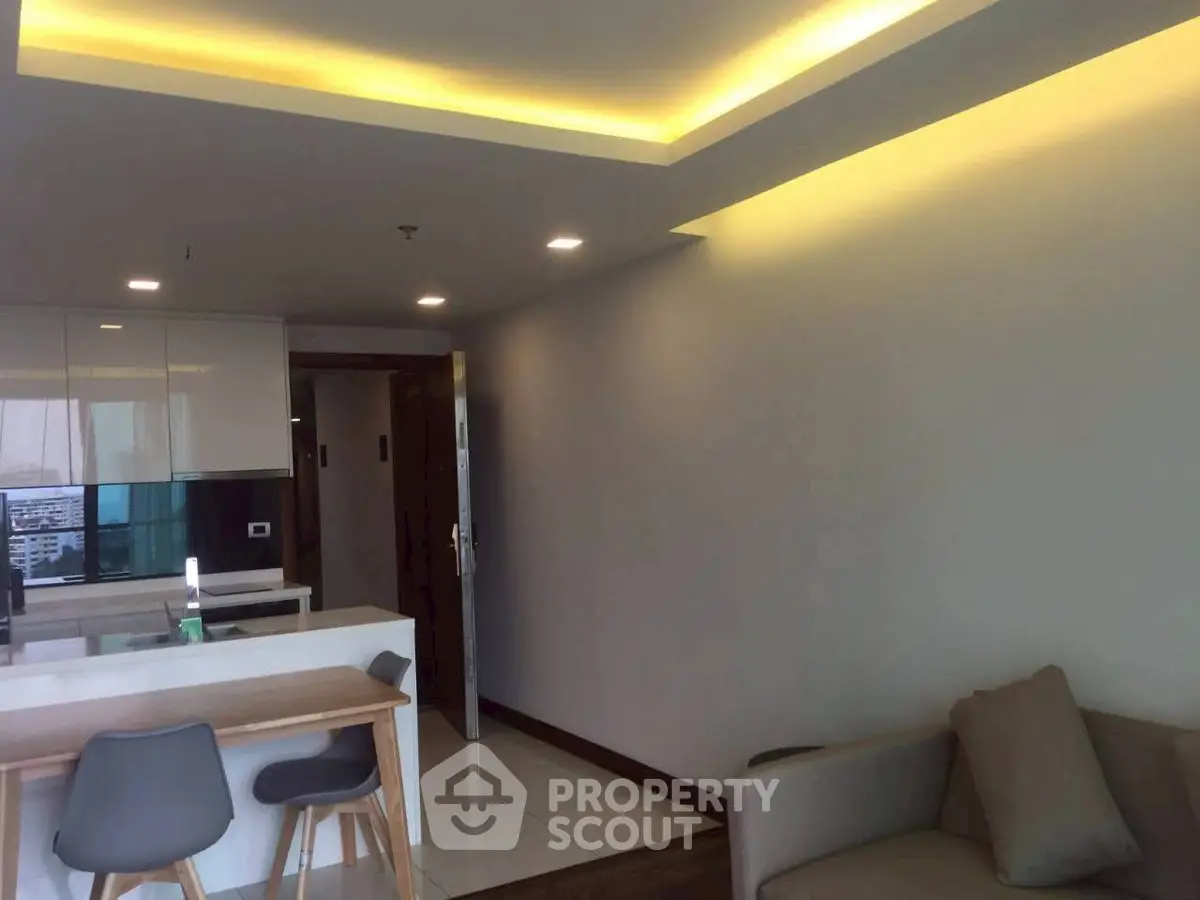 Modern living room with open kitchen and stylish lighting