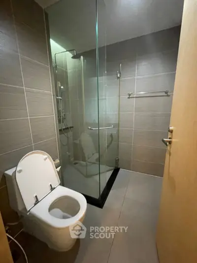 Modern bathroom with glass shower and sleek tile design