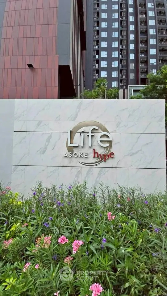 Modern condominium exterior with lush garden at Life Asoke Hype