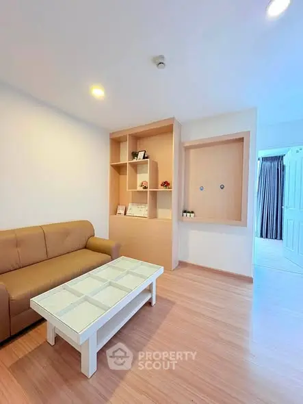 Modern living room with cozy sofa and stylish shelving in a bright apartment.