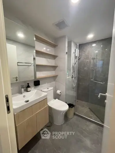 Modern bathroom with sleek design, glass shower, and elegant fixtures in a contemporary home.