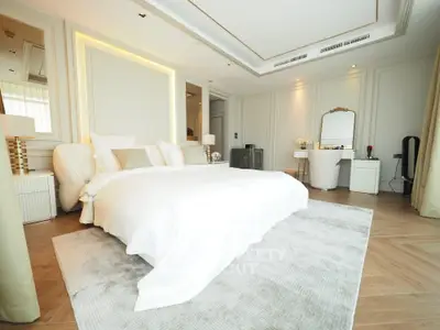 Luxurious bedroom with elegant decor and plush bedding in a modern home.