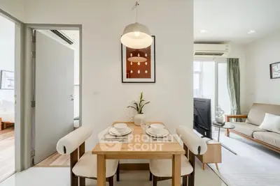 Modern open-plan living and dining area with stylish decor and natural light.