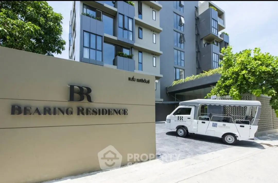 Modern urban apartment building with sleek design and branded shuttle service at Bearing Residence.