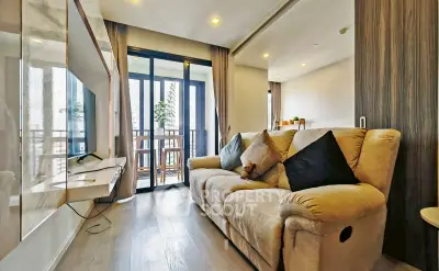 Modern living room with cozy sofa and balcony view in a stylish apartment