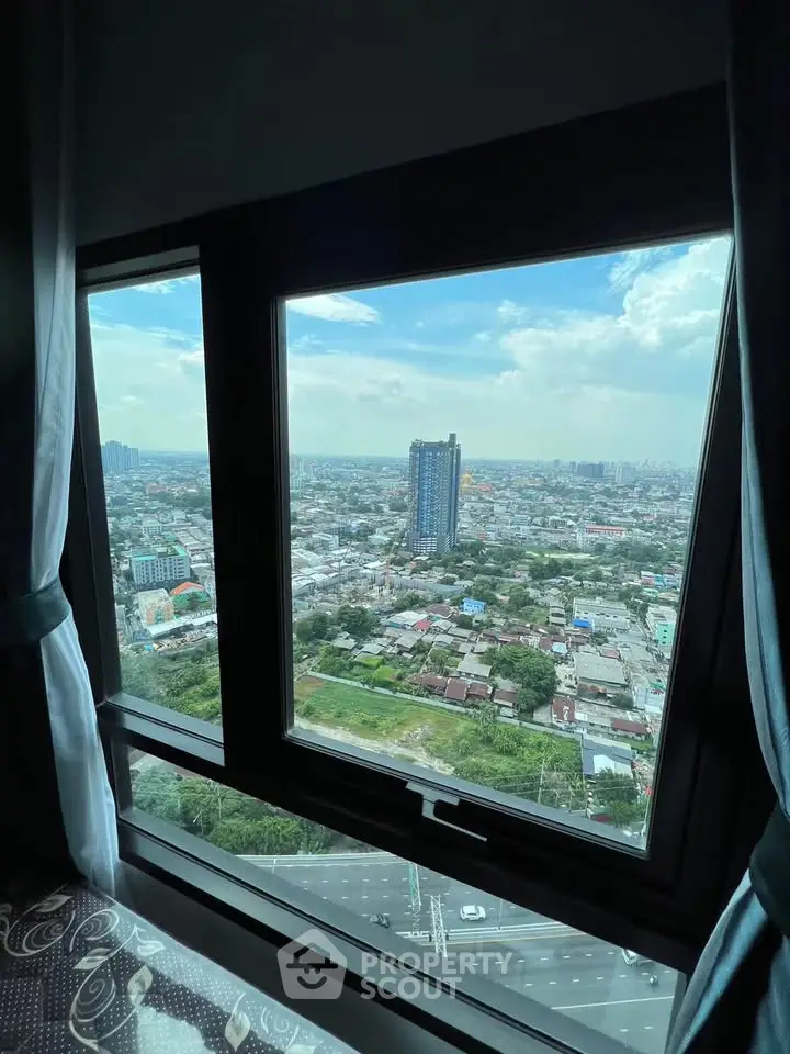 Stunning cityscape view from a high-rise apartment window, showcasing urban living at its finest.