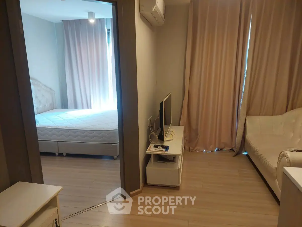 Cozy apartment interior with bedroom and living room, featuring modern furniture and soft lighting.