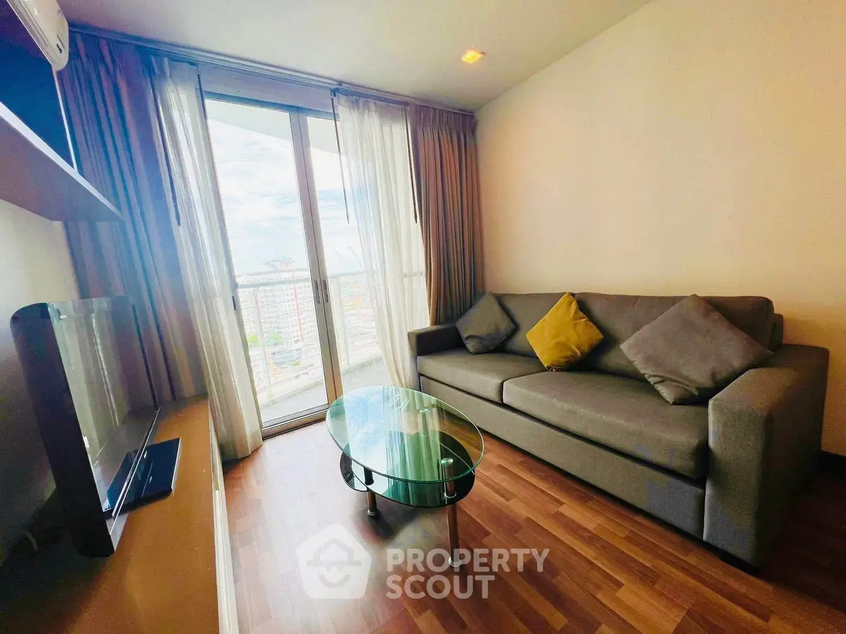 Modern living room with large window and stylish furniture in a cozy apartment.