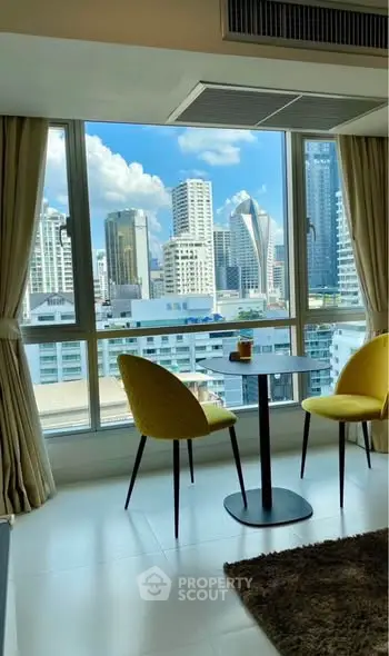 Modern apartment with stunning city view from large window and cozy dining area.