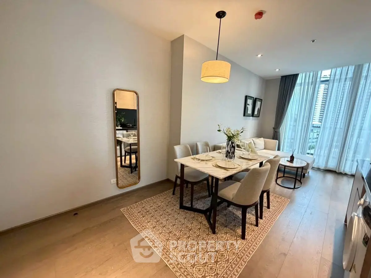 Elegant dining area with modern decor and large windows in a luxury apartment.