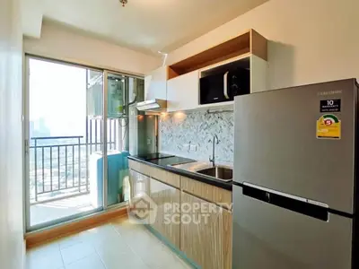 Modern kitchen with balcony view in high-rise apartment