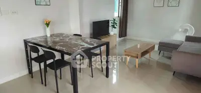 Modern living room with sleek marble dining table and cozy seating area