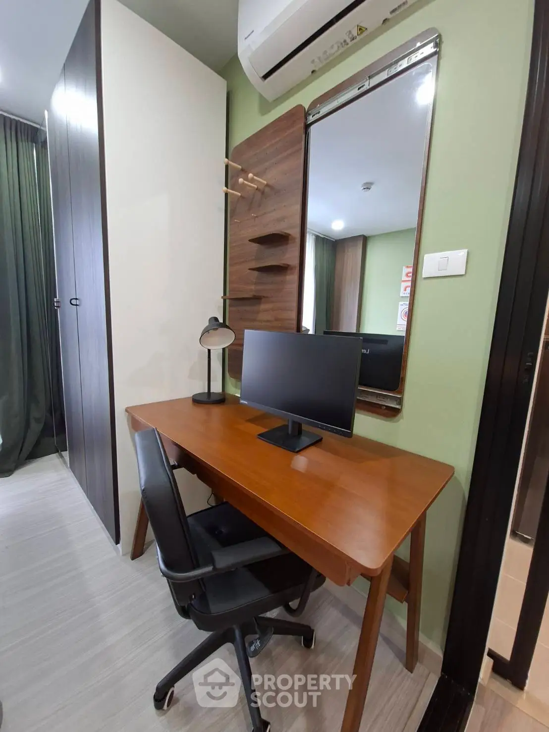 Modern study area with sleek desk, chair, and monitor in stylish apartment