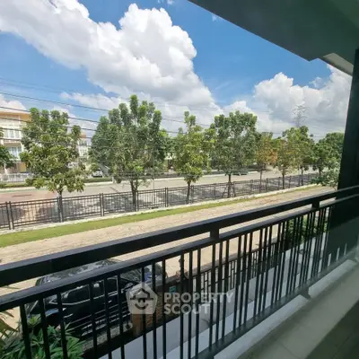 Spacious balcony with scenic view of trees and clear blue sky, perfect for relaxation.
