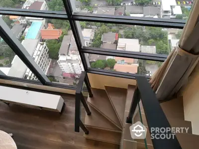 Stunning high-rise view from modern staircase with floor-to-ceiling windows