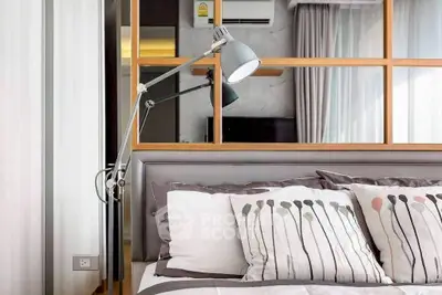 Modern bedroom with stylish decor and elegant lighting in a contemporary apartment.