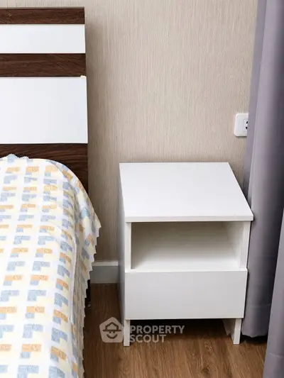 Modern bedroom with stylish nightstand and cozy bedding