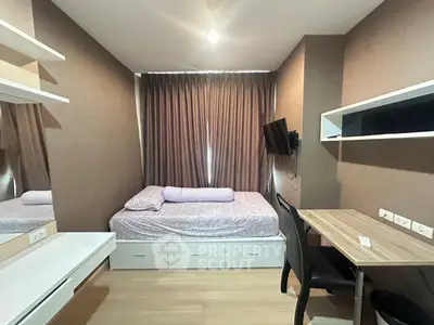 Cozy bedroom with modern furnishings and ample storage in a stylish apartment.