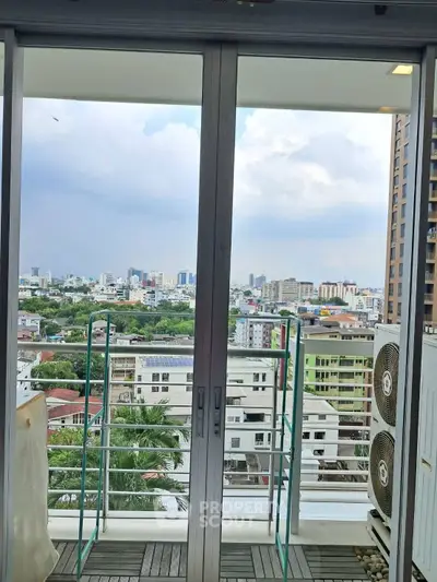 Spacious balcony with stunning city view in modern high-rise apartment.
