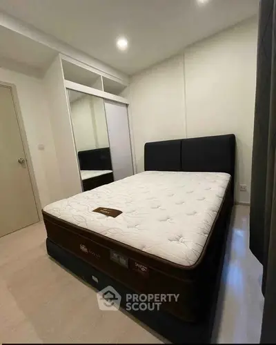 Cozy bedroom with a comfortable bed and built-in wardrobe, perfect for restful nights.