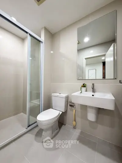 Modern bathroom with sleek fixtures and glass shower enclosure
