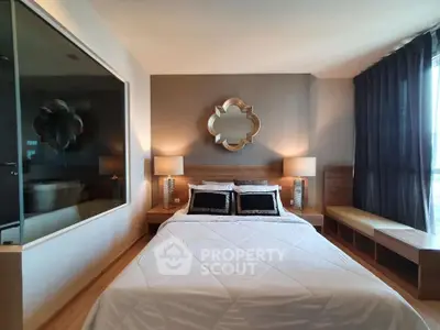 Luxurious bedroom with elegant decor and large window offering natural light.