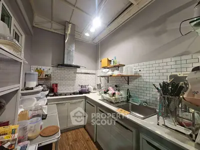 Charming kitchen with modern appliances and stylish backsplash in cozy home.