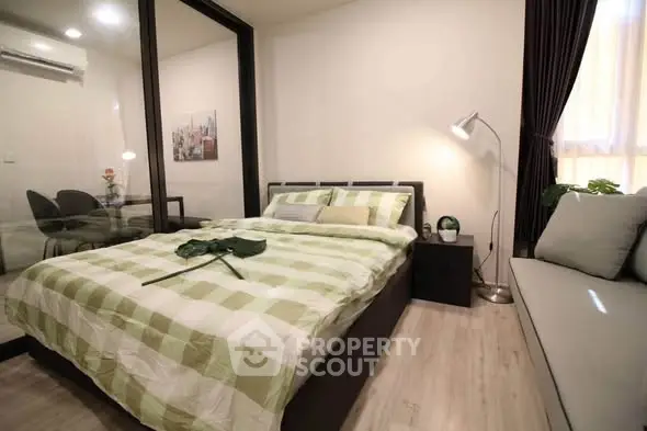Modern bedroom with stylish decor and glass partition in a cozy apartment.