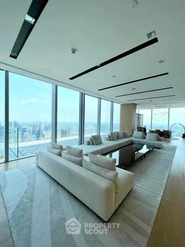 Luxurious modern living room with panoramic city views and elegant white sofas