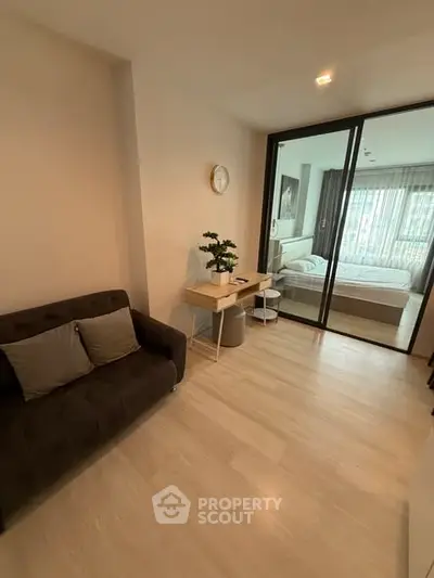 Modern apartment interior with cozy living area and bedroom view
