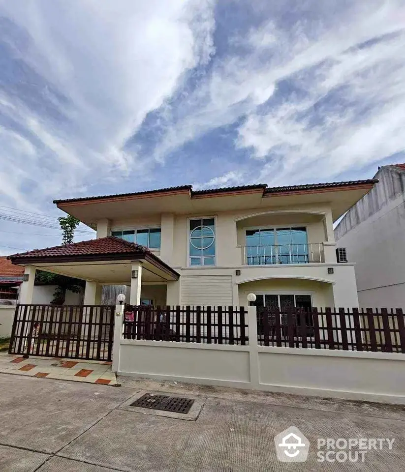 Charming two-story house with modern design and spacious balcony in a serene neighborhood.