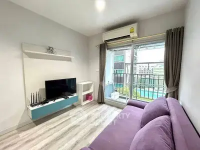 Modern living room with balcony view and sleek furniture in urban apartment.