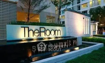 Modern building entrance with illuminated signage at The Room Sukhumvit 79.