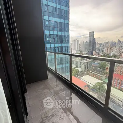 Stunning cityscape view from modern high-rise balcony with sleek glass railing.
