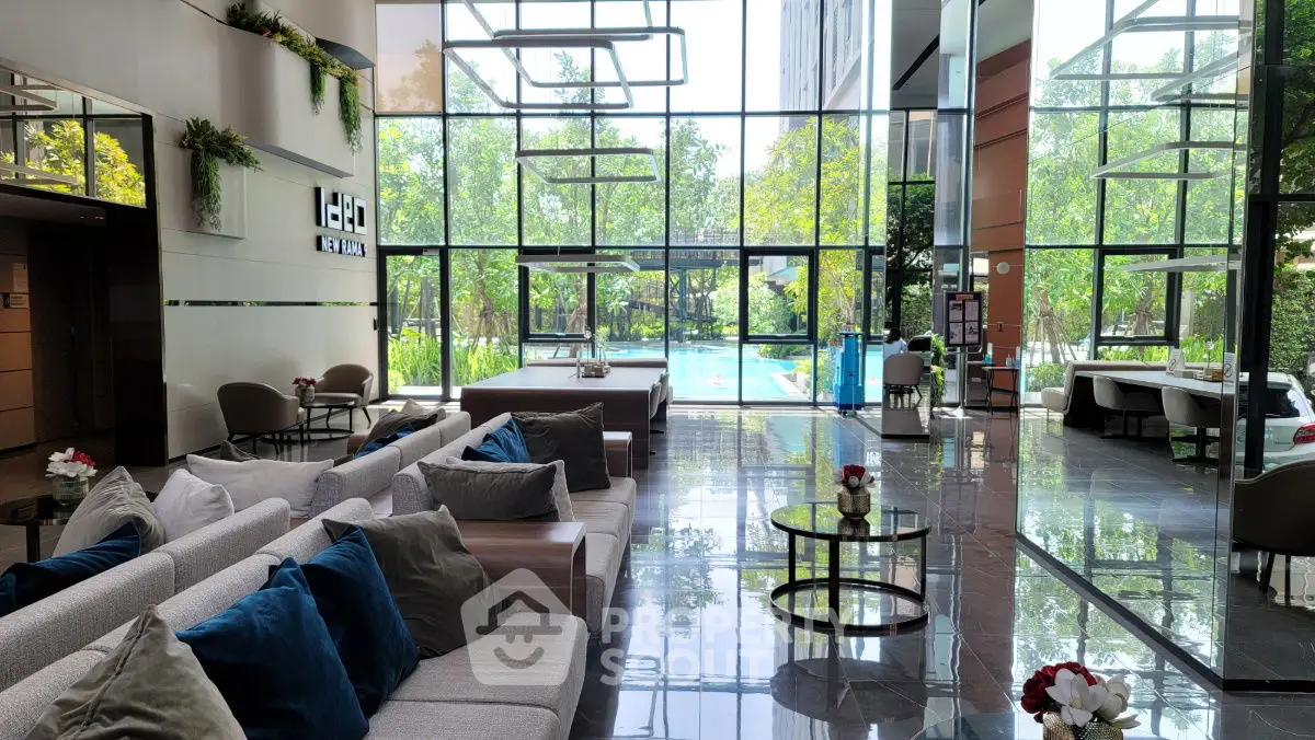 Luxurious modern lobby with pool view and elegant seating area