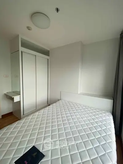 Modern bedroom with sleek wardrobe and comfortable mattress in a minimalist design.