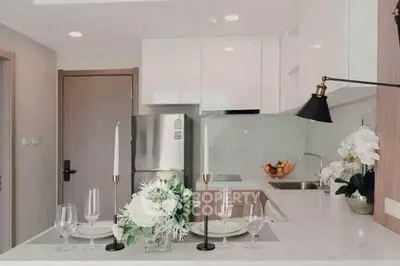 Modern kitchen with sleek white cabinets and elegant dining setup