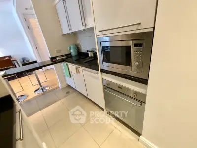 Modern kitchen with sleek appliances and open layout in a stylish apartment.