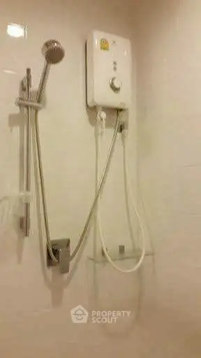 Modern bathroom with sleek showerhead and water heater, ideal for comfort and convenience.