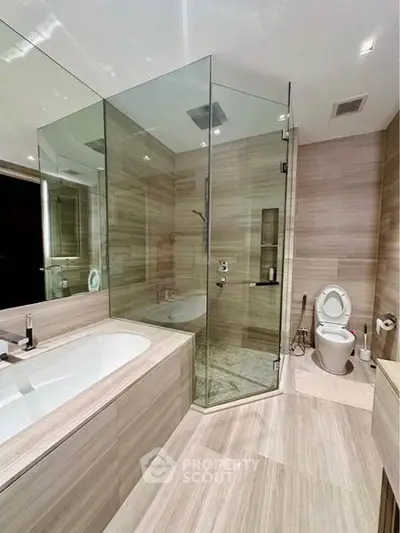 Luxurious modern bathroom with glass shower and bathtub in elegant design.