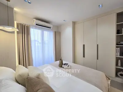 Modern bedroom with elegant decor and ample natural light