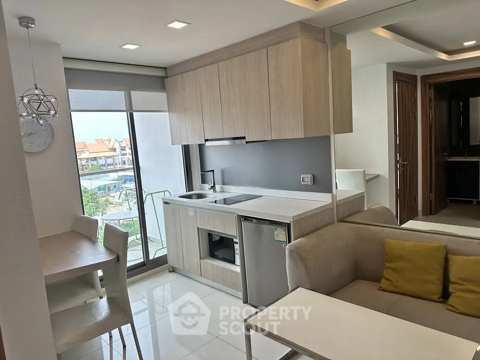 Modern open-layout kitchen with sleek design and cozy living area, perfect for urban living.